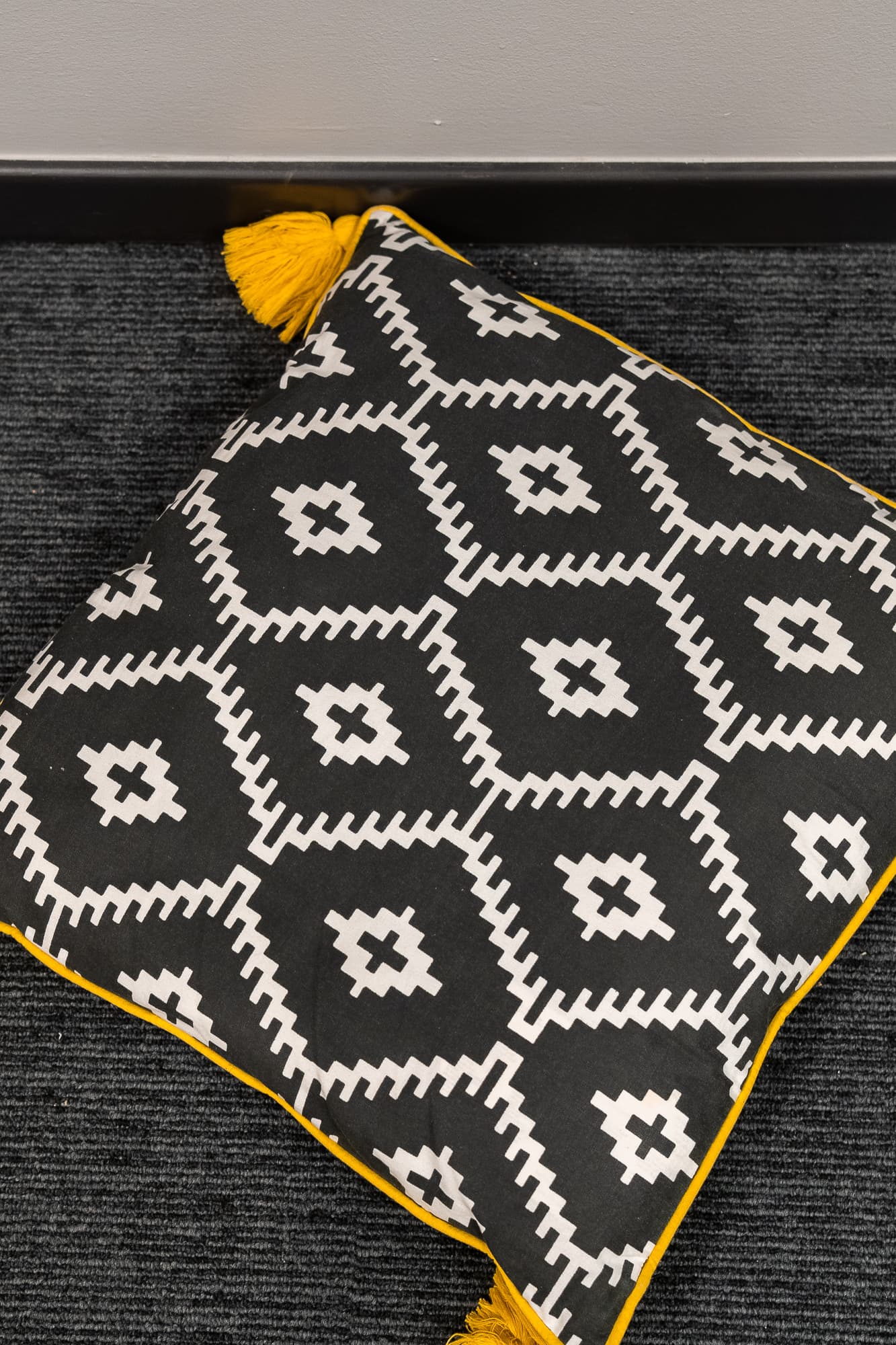 black cushion with white diamond pattern and tassels-2